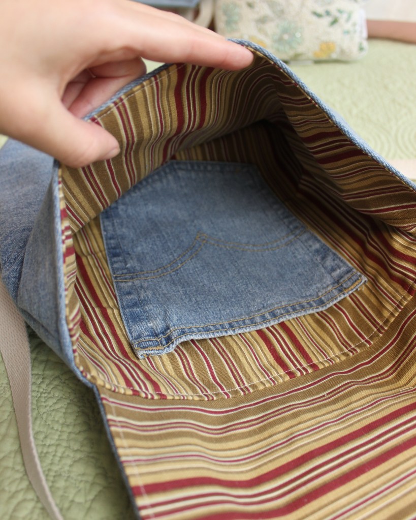 The inside of a handmade denim bag, showing an inner pocket