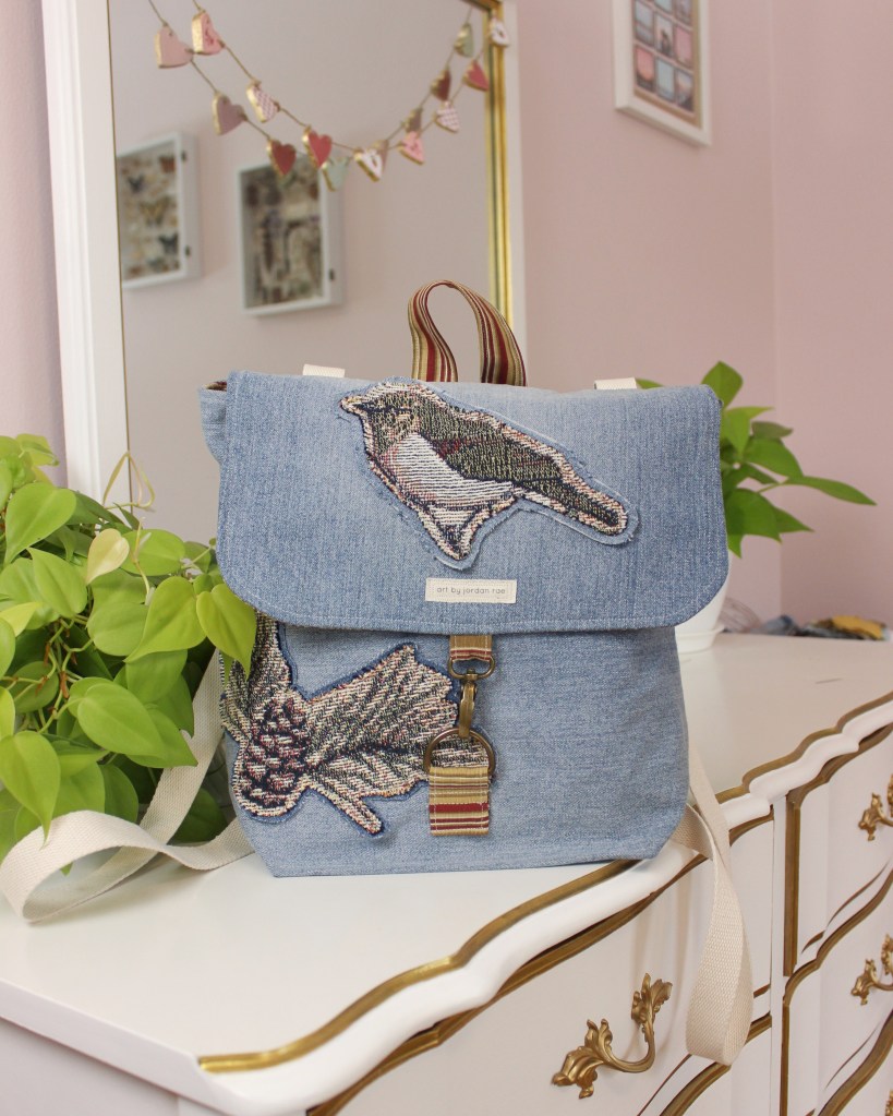 A handmade denim bag sitting on a dresser